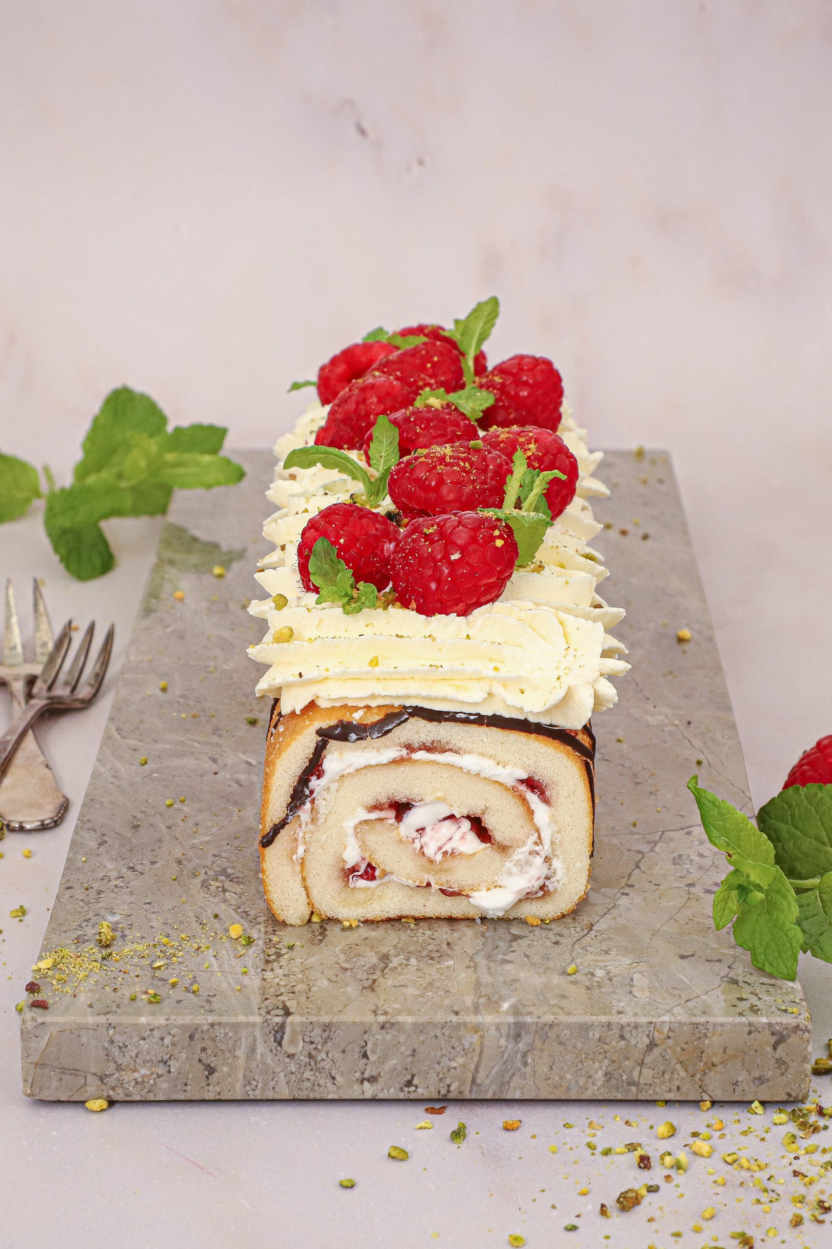 Nem roulade dessert lavet af en købt hindbærroulade toppet med mascarponecreme, pistacie og friske hindbær.